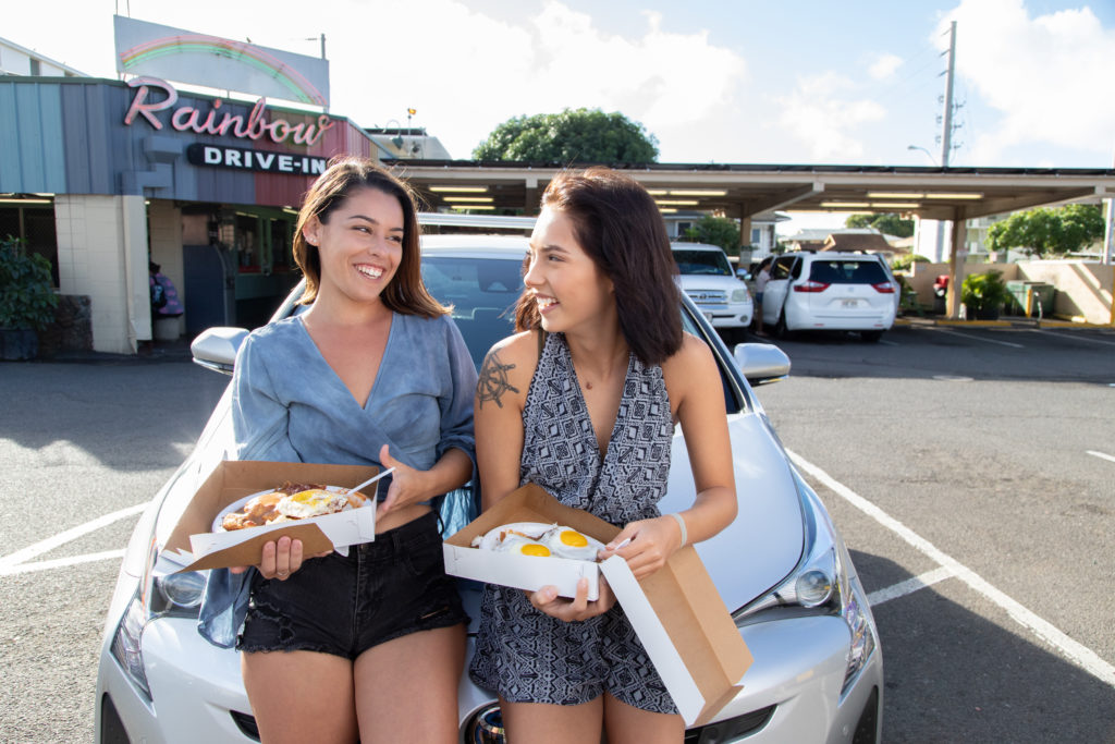 friends enjoy plate lunches at Rainbow Drive In on Oahu